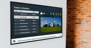 Smart TV mounted on wall with Q-Play digital signage layout