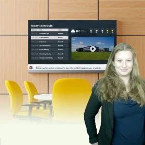 Digital signage screen and the presenter of the webinar.